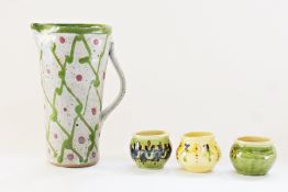 A studio pottery stoneware jug, with green and red pattern together with three other items (4)