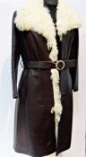 1970s brown leather coat, with sheepskin collar and trim to one side, pockets, and a brown leather