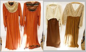 Various 1970s dresses, including a brown velvet dress with heavily embellished yoke, a similar