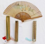 Three Chinese pierced wooden fans in glazed boxes, and painted wooden and paper fan, floral