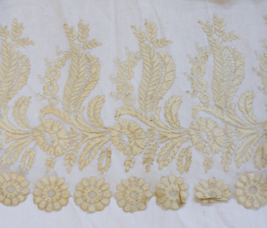 A large circular piece of undyed silk lace, floral pattern with scalloped edges, 78cm long