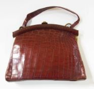 Brown crocodile handbag, with gilt clasp