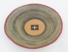 20th century studio stoneware plate, dark brown glaze, green matt surface, orange circular form to