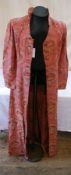 A 1920's housecoat with embroidered damask material, buttons to front, half stand-up collar, one