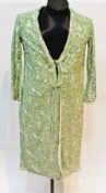 A 1920's green silk embroidered Chinese/oriental dressing gown with double button detail and cream
