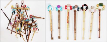 Approximately thirty eight lace bobbins with beaded decoration