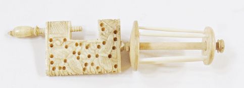 Carved bone thread bobbin with clamp, the clamp decorated with butterflies