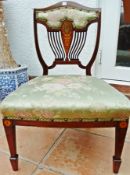 Edwardian mahogany nursing chair, the padded shield-shape back with pierced and inlaid splat,