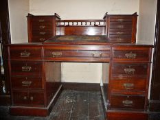 Edwardian walnut desk, the superstructure having twin banks of four drawers united by a turned