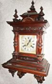 Edwardian walnut bracket clock, the domed top having three turned pilasters, carved and moulded