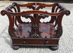 Victorian mahogany two-division Canterbury, having carved, shaped and moulded frame, fitted drawer