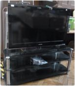 A Samsung flat screen television, 42", black surround with remote control and a black glass and