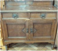 20th century oak sideboard, with two drawers above cupboards on turned supports, carved edges and