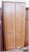 Large double wardrobe, pair panelled doors with brass swan-neck handles, enclosing hanging rail