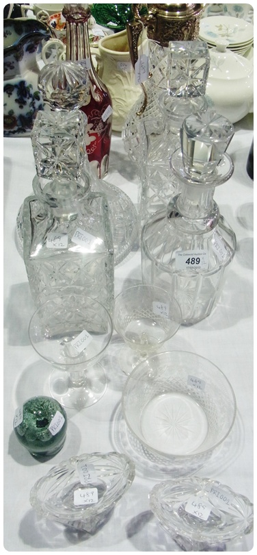 Quantity of cut glass decanters, a claret jug with silverplate top, a paperweight and other assorted