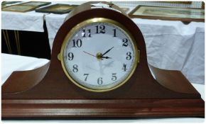 A 20th century reproduction electronic mantel clock with enamelled dial