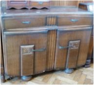 20th century oak sideboard with concave front, with two drawers and cupboards below, with carved