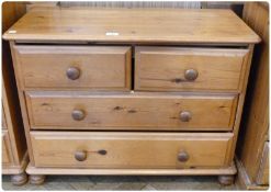 Modern pine chest of two short and two long drawers on bun feet, 83cm wide