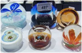 Six assorted paperweights, to include Caithness "Midnight Millenium", "Miniature Pansy" and four
