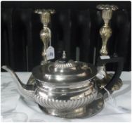 EPNS teapot, gadrooned decoration, black handle and finial, pair foliate silverplated candlesticks