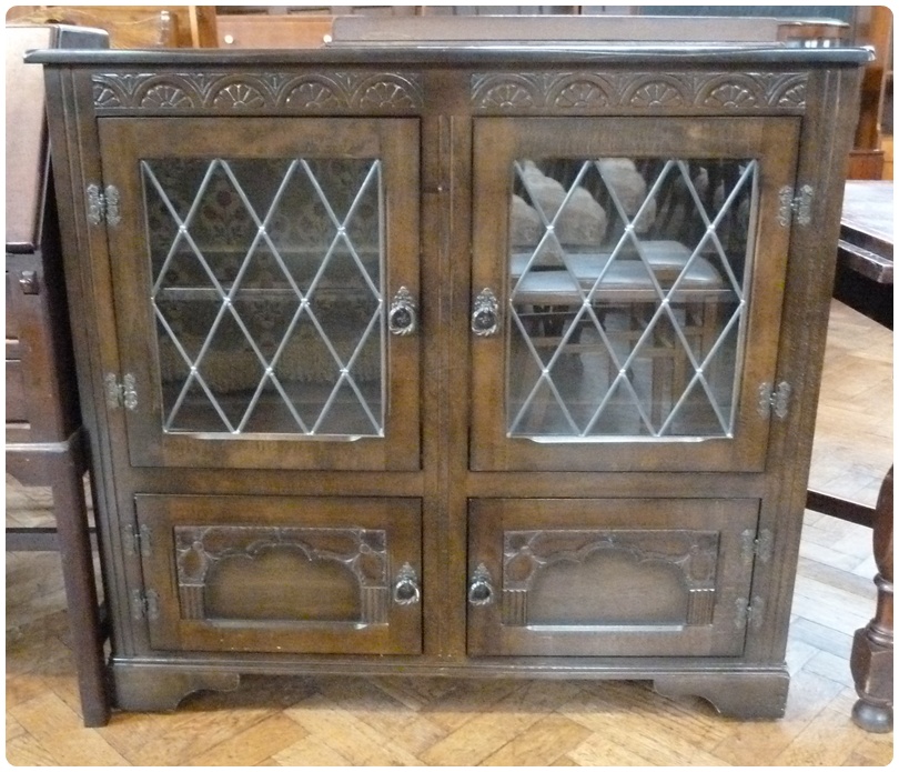 Twentieth century oak display cupboard, astragal glazed doors enclosing two shelves and smaller