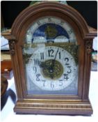 A modern oak cased mantel clock with moonphase dial, modern silvered chapter ring