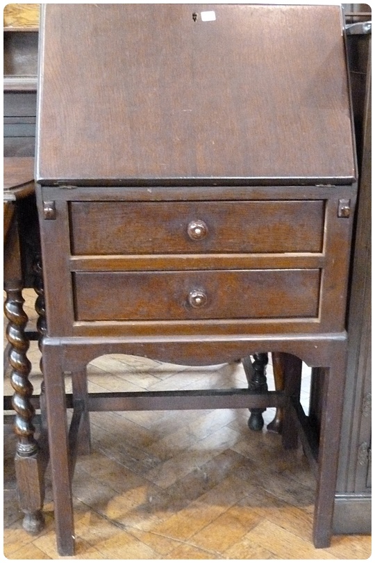 Twentieth century oak bureau, with hinged top enclosing pigeonholes and drawers, two drawers