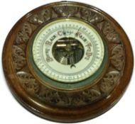 A mahogany carved circular barometer