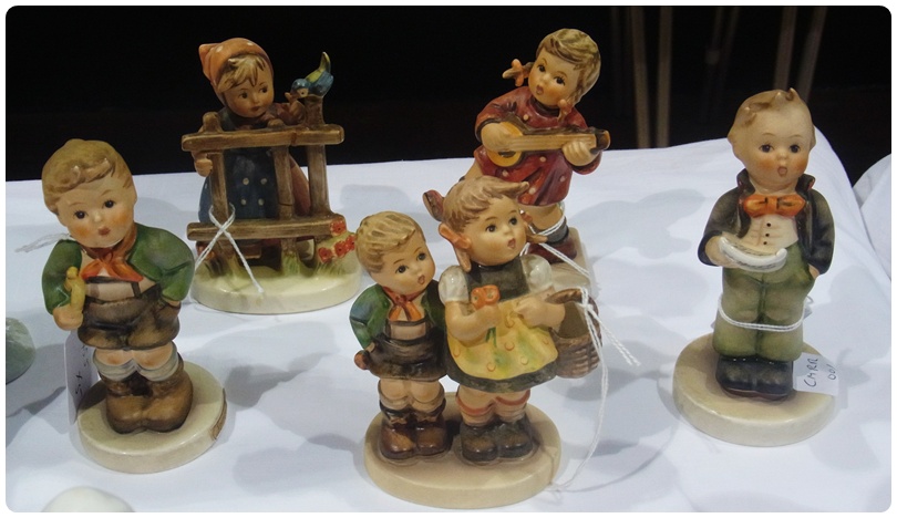 Five Goebel Hummel figures, "Trumpet Boy", "Boy Singing", "Happiness", "Girl at Fence With Bird" and