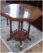 Late Victorian walnut occasional table with octagonal top and under-platform on castors