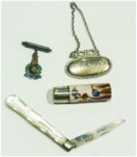 Silver-bladed folding fruit knife, with mother-of-pearl scales, a silver decanter bottle label, "