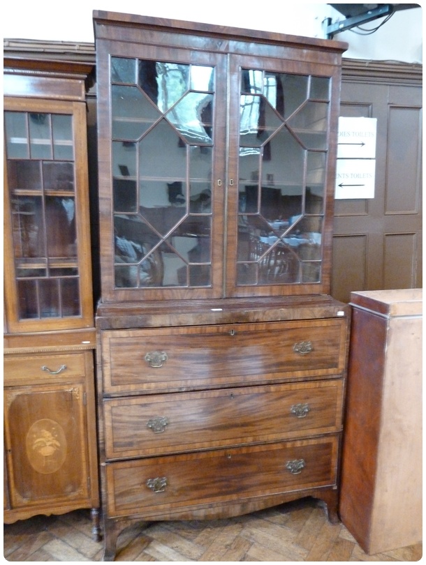 A Georgian mahogany secretaire bookcase, the pair astragal glazed doors enclosing adjustable