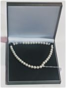 String of freshwater pearls, 12-13mm in 18ct gold plated mount