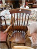 Nineteenth century beech and elm lathback armchair, with solid seat, on ring-turned legs united by