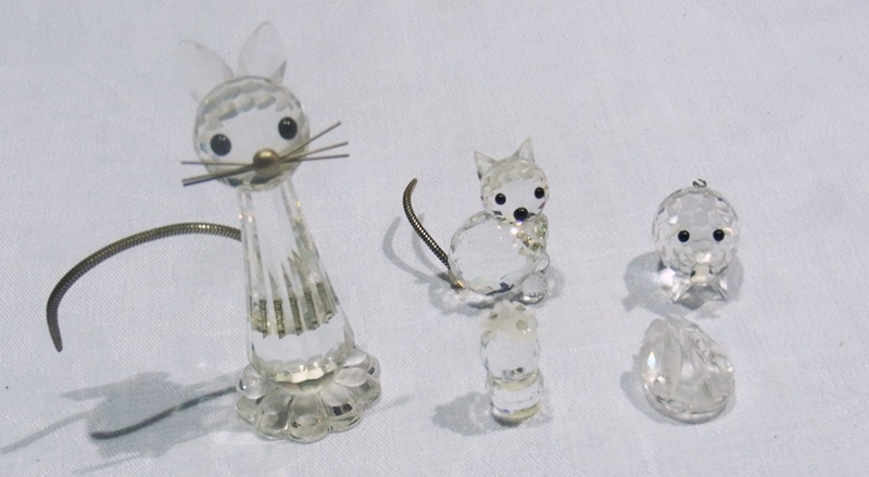 Swarovski figures, including a cat, a mouse, an owl, a miniature pig, a miniature swan, and a
