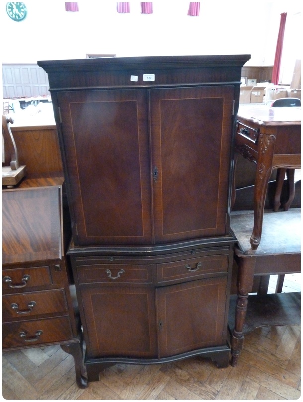 Reproduction mahogany serpentine front cocktail cabinet, the upper section with mirrorback and