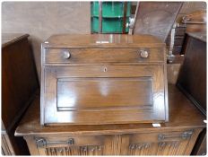 Reproduction oak writing slope, with frieze drawer, and fitted interior with carrying handles,