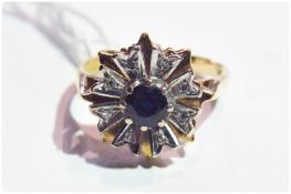 Gold coloured metal, sapphire and diamond flowerhead ring, with central sapphire surrounded by eight