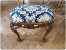 Georgian style walnut oval stool, with drop-in upholstered seat, on foliate carved cabriole legs