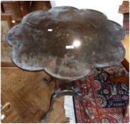 A Georgian style mahogany petal top side table, on turned column supports to quadruped splayed legs,