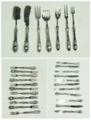 Set of eleven silver handled dessert knives and forks, together with seven silver handled serving