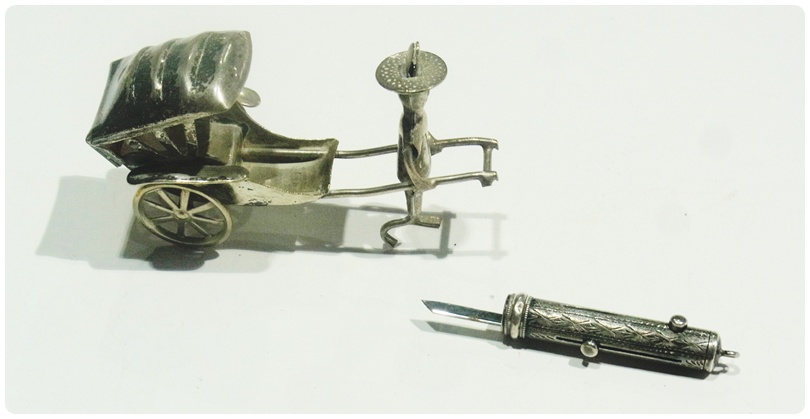 Eastern silver model of a rickshaw, together with a white metal case containing  pencil, toothpick