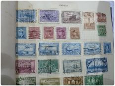 A stamp album of many late 19th/early 20th century stamps