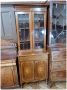 An Edwardian Sheraton style glazed mahogany bookcase, with satinwood inlaid and cross-banding, the