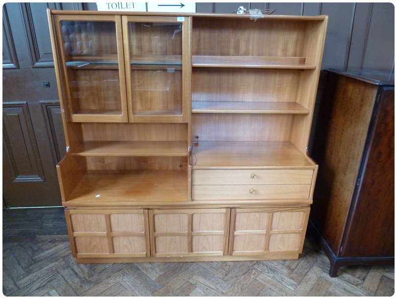 Modern hardwood wall unit comprising a glazed cupboard, open shelves and two drawers with three