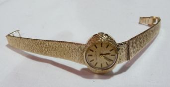 Longines lady's 9ct gold watch, with gold face, bark finish surround and integral bracelet, in Omega