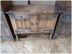 Reproduction oak side cupboard, the pair of linenfold drawers enclosing shelf, on baluster turned