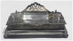 A Victorian silver inkstand, with pierced fretwork back, central box with hinged cover, and pair