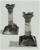 Pair Georgian style table candlesticks, on Corinthian columns, with square stepped bases, London