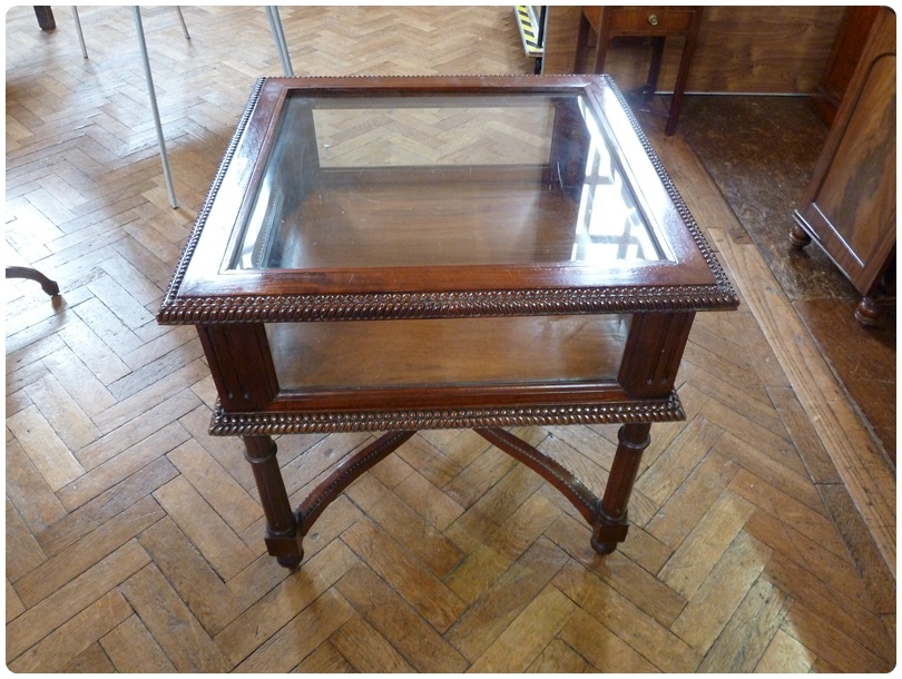 Nineteenth century style square mahogany display table, with bevel glazed top and sides and carved